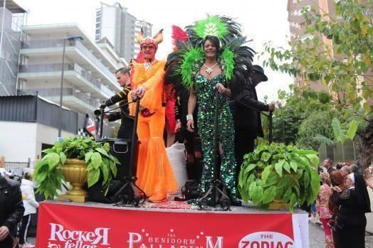 Performers in sequins and feathers on a cabaret bar float, 2019