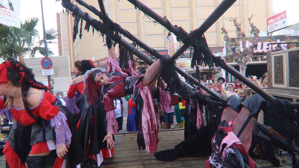 Pirates in red and black on a pirate ship float, 2023