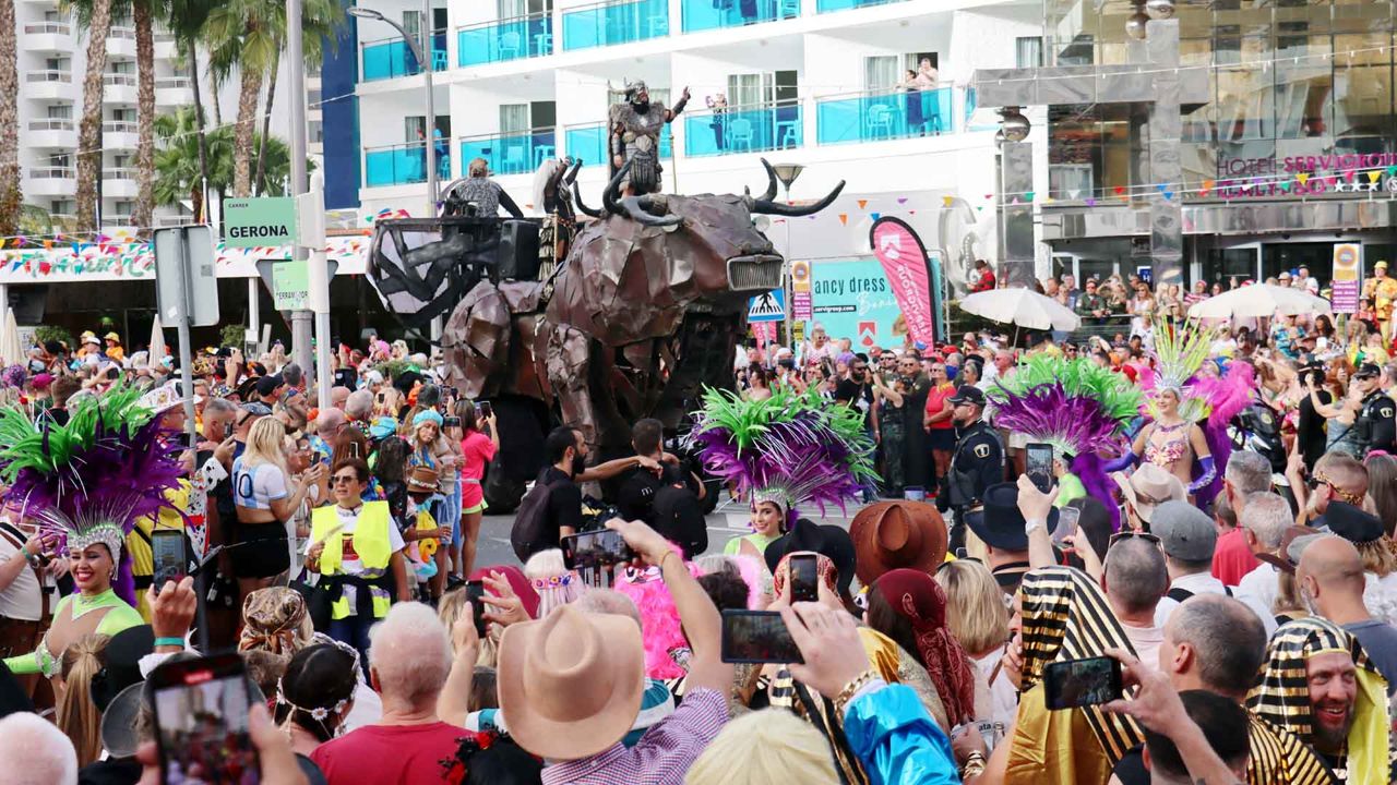 A float with a giant bull and carnival dancers in feathered headdresses, 2025