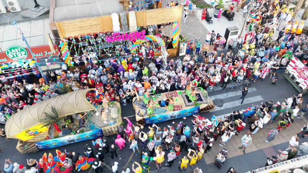 Floats and crowds on the parade route from above
