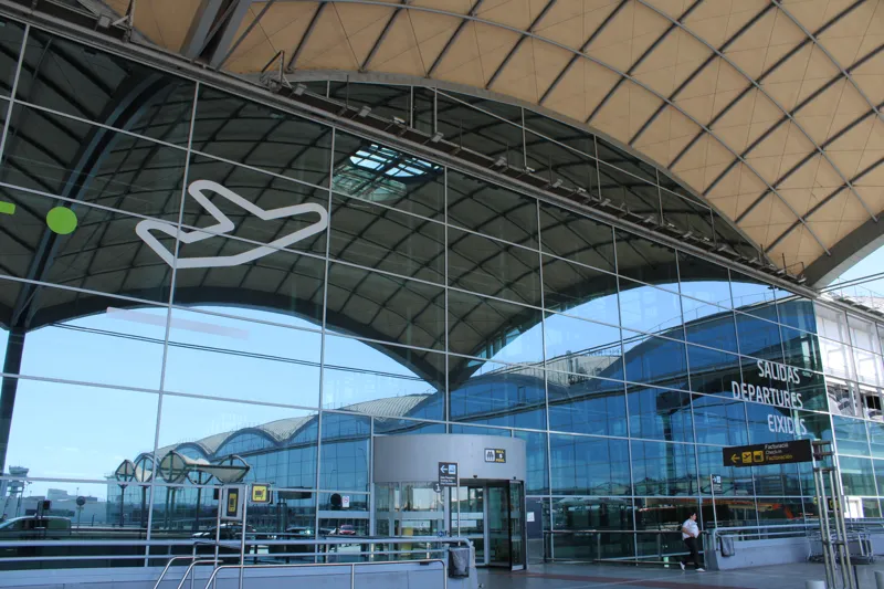 The glass front of Alicante–Elche airport's departures level in June 2024