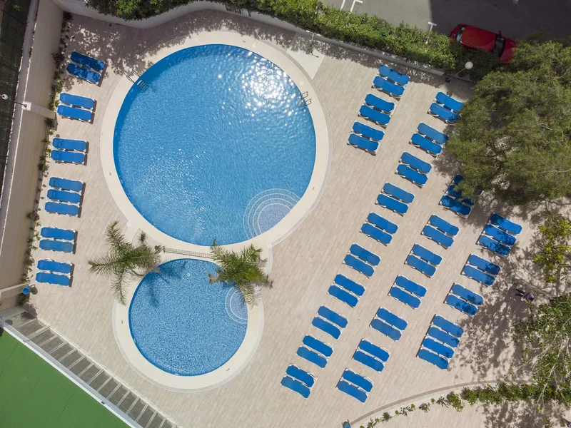Levante Lux: Pools from above, Two round pools ringed by rows of blue loungers