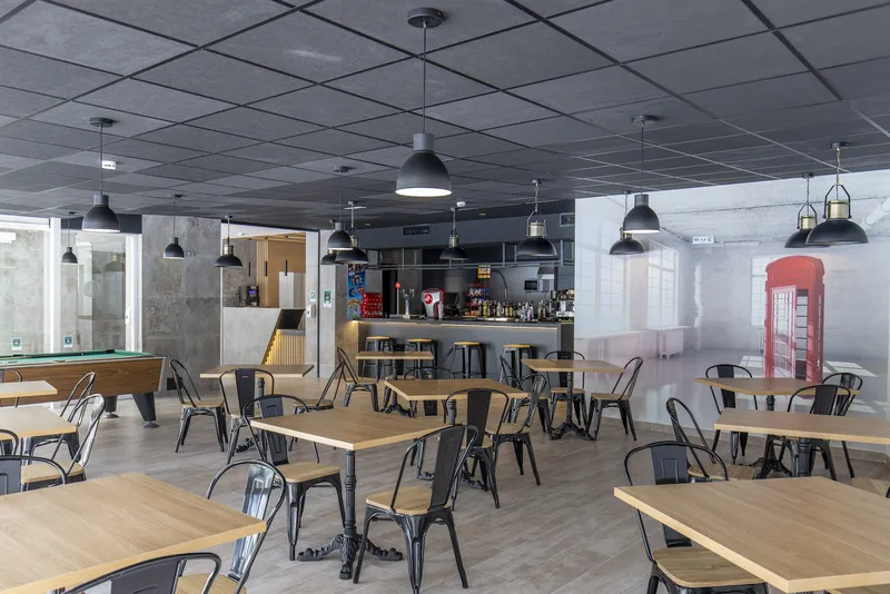 Levante Lux: Bar, Bar and lounge with wooden tables, pool table and red phone box