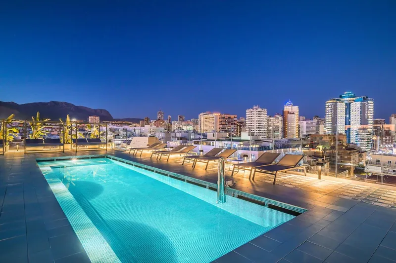 Barceló Beach: Rooftop pool, Rooftop pool and loungers at dusk with the skyline behind