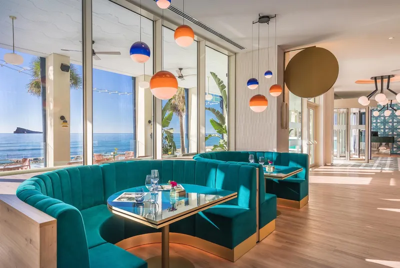 Barceló Beach: Restaurant booths, Curved teal booths by windows looking out to sea