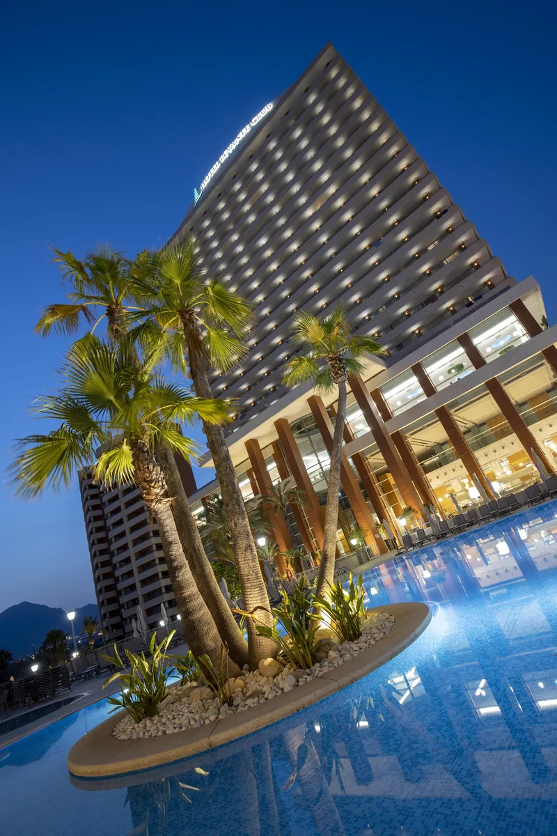 BCL Levante Club: The hotel at night, Hotel tower lit up above the pool and palm island