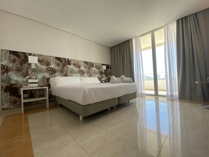 BCL Levante Club: Double room, Double bed, leaf-print wall and full-height windows