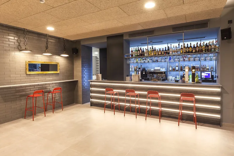 Benidorm Centre: Bar, Bar counter with red stools and lit shelves