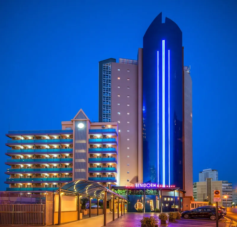 Benidorm Plaza: The hotel at night, Hotel blocks and glass tower lit up at dusk