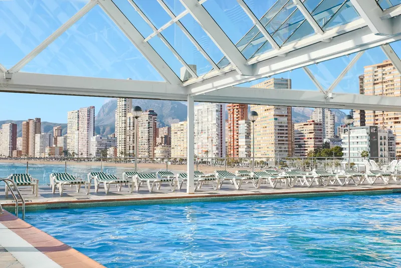 Benikaktus: Glass-roofed pool, Pool under a glass roof looking across the bay to the high-rises