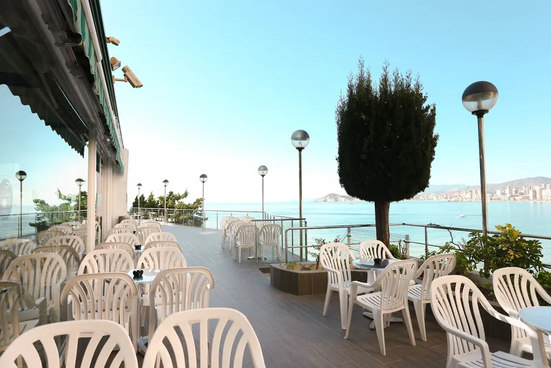 Benikaktus: Terrace, Outdoor terrace with white chairs and tables above the sea
