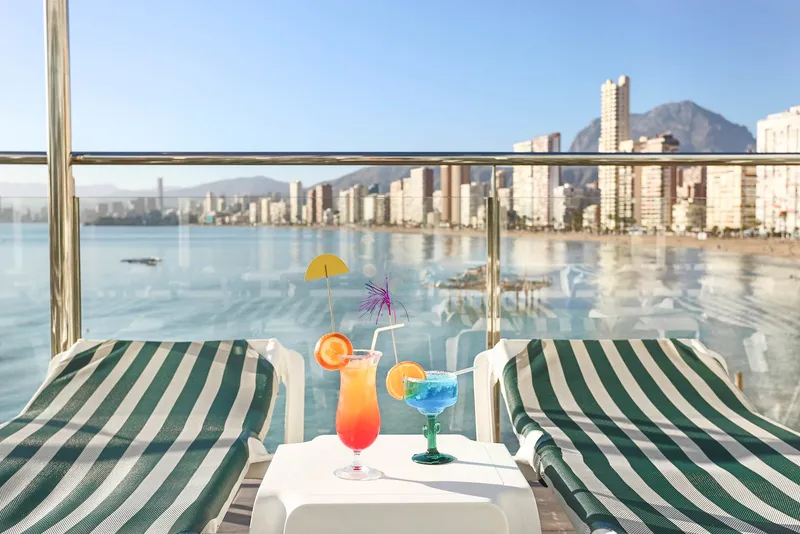Benikaktus: Balcony, Two striped loungers and cocktails on a balcony over the bay