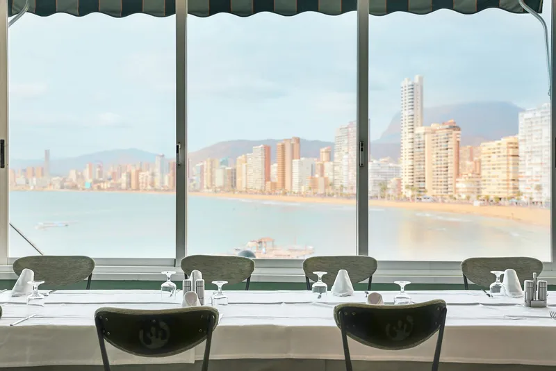 Benikaktus: Restaurant, Dining tables set beside large windows overlooking the bay