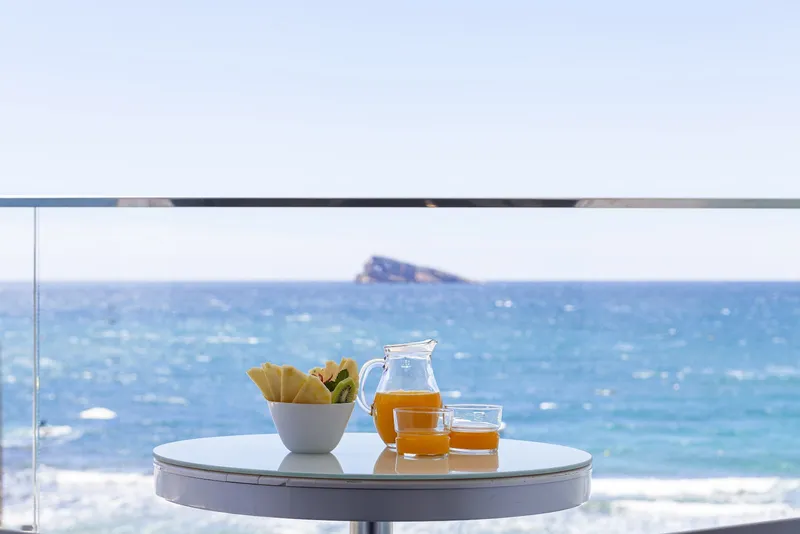Brisa: Balcony breakfast, Juice and fruit on a table with sea and island view