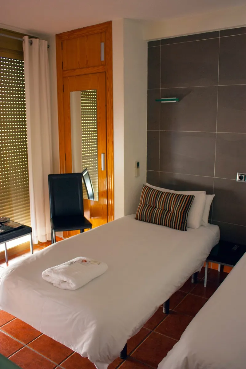 Casa Don Juan: Single room, Single bed with towels and wood-framed window