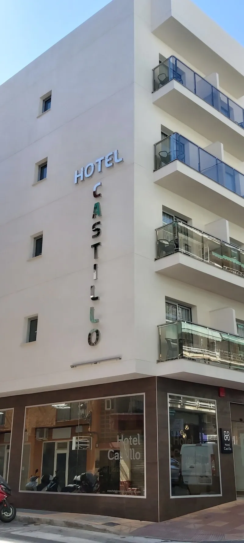 Castillo: The hotel, Hotel building with balconies and vertical Castillo sign on the street