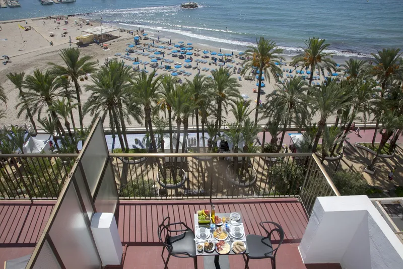Casual Pop Art: Sea-view terrace, Terrace with breakfast table above palms and beach