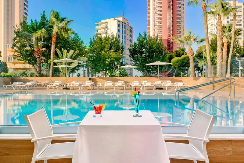 Don Pancho: The pool terrace, Tables by the pool, with the Levante towers behind