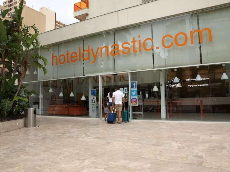 Dynastic: Entrance, Glass entrance with hoteldynastic.com lettering