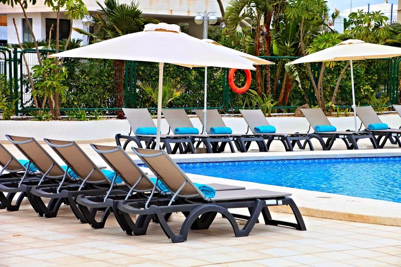 Flamingo: Pool loungers, Rows of loungers and parasols by the pool