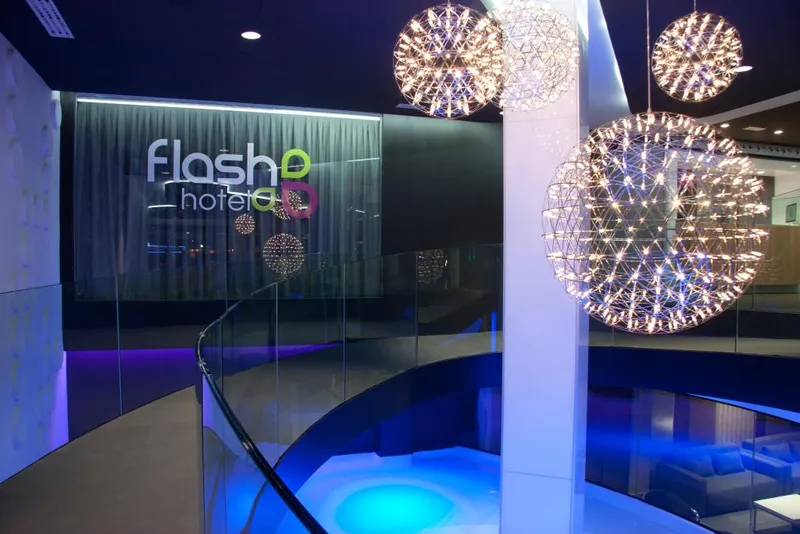 Flash: Lobby, Lobby with spherical pendant lights and blue-lit glass