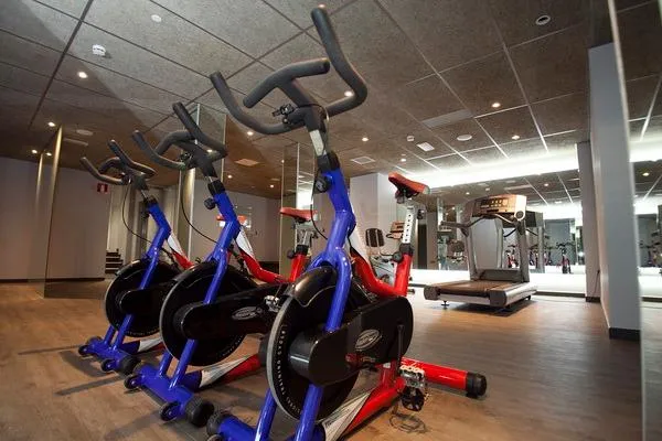 Flash: Gym, Exercise bikes and treadmills in a timber-floored gym