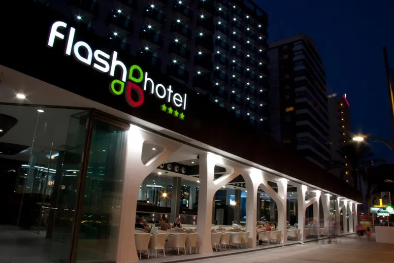 Flash: The hotel at night, Lit facade and glass-fronted ground floor after dark