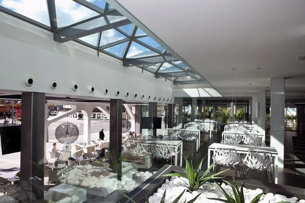 Flash: Terrace lounge, White tables and seating under a glass roof