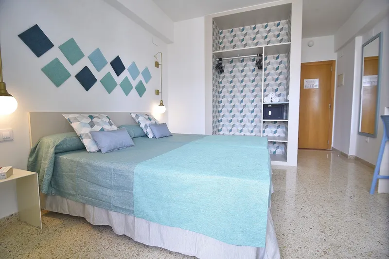 Gala Placidia: Twin room, Twin beds in turquoise covers with tiled wall pattern and wardrobe
