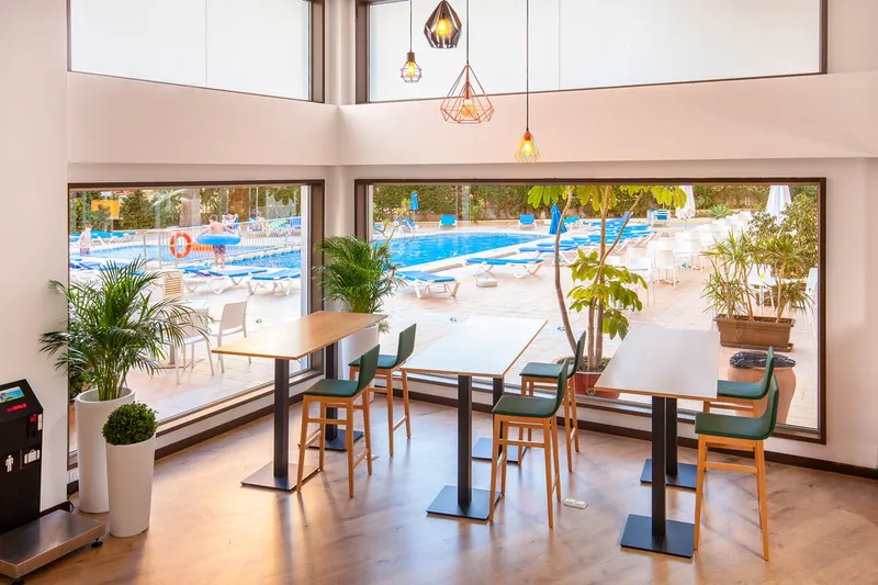 Gala Placidia: Café overlooking the pool, High tables and stools by large windows onto the pool and loungers
