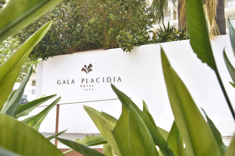 Gala Placidia: Hotel sign, Gala Placidia sign on a white wall framed by plants