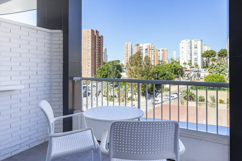 Golden: Balcony, Balcony with table and chairs over trees and towers