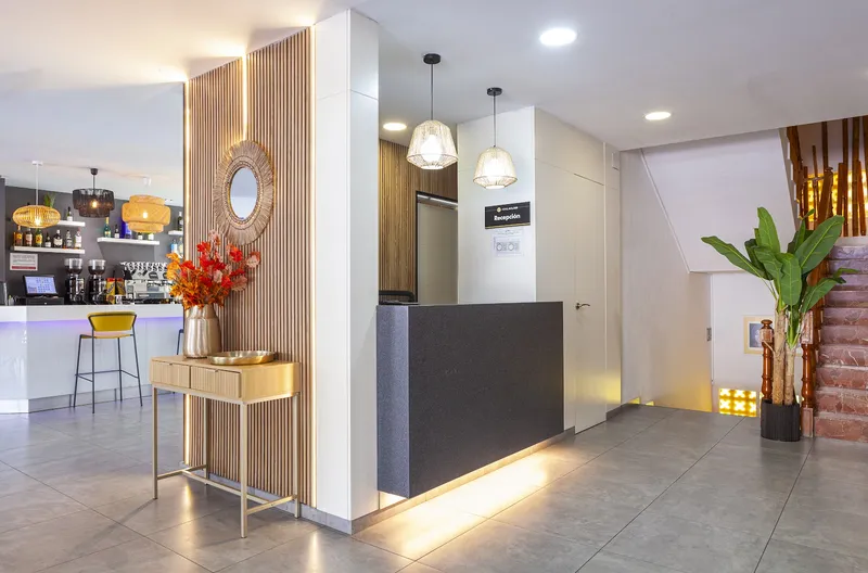 Golden: Reception and bar, Reception desk beside a small bar and staircase