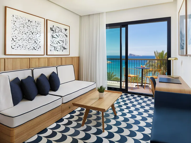 Porto Poniente: Sea-view room, Sofa and coffee table by balcony doors to the sea