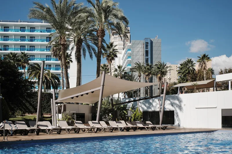 Helios: Pool, Outdoor pool with loungers, shade sails and palms