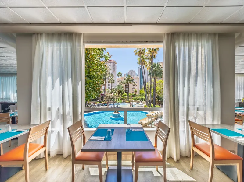 Medsur Alone: Dining room, Laid tables by a window looking onto the pool