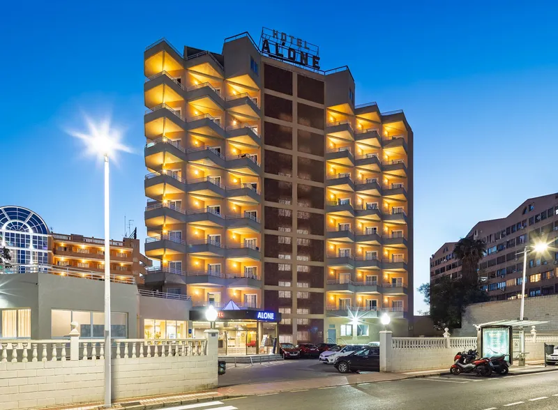 Medsur Alone: The hotel at dusk, Hotel Alone tower with lit balconies at dusk
