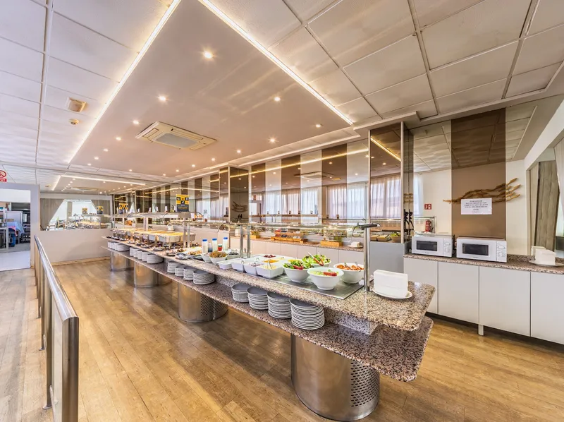 Medsur Alone: Buffet, Buffet counters with salads and stacked plates