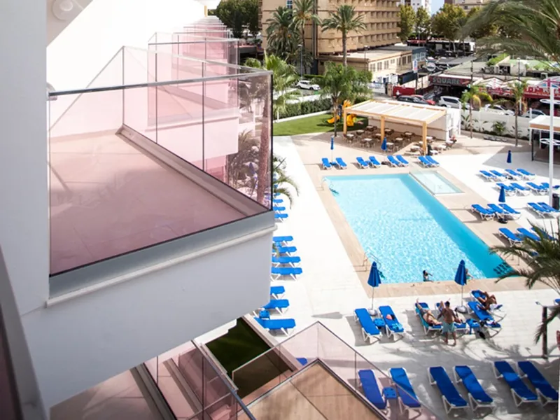 Ambassador Playa II: The pool, Pool and sunbeds from a balcony