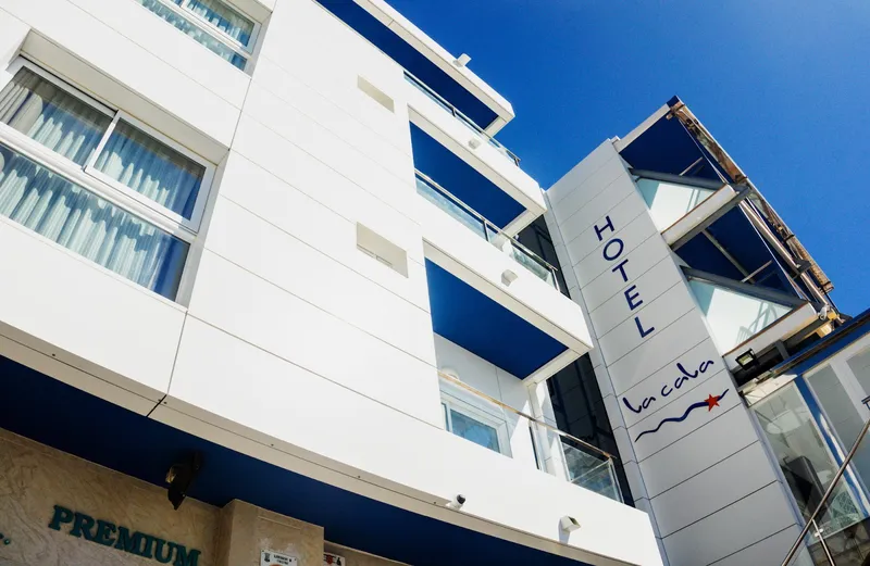 La Cala: The hotel, White facade with blue balconies and hotel sign