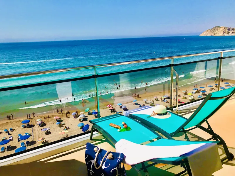 Marconi: Beach view, Loungers behind a glass rail above a busy beach