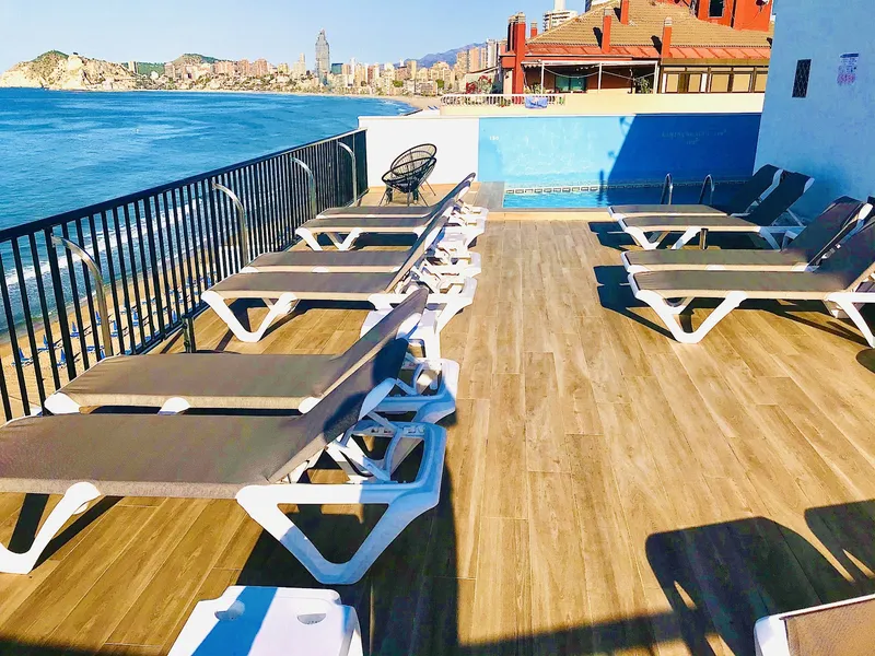 Marconi: Rooftop terrace, Loungers on a wooden deck beside a small rooftop pool