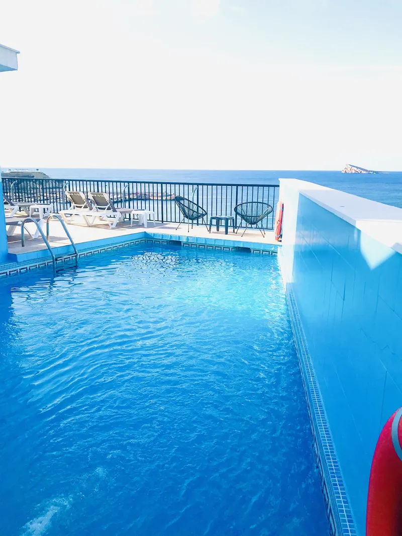 Marconi: Rooftop pool, Narrow pool with a glimpse of the sea beyond