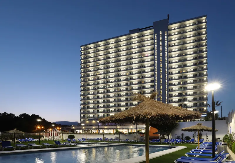 Poseidón Playa: The hotel at night, Lit hotel tower and pool at dusk