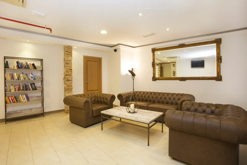 Hotel Queens: Lounge, Chesterfield sofas and a book shelf
