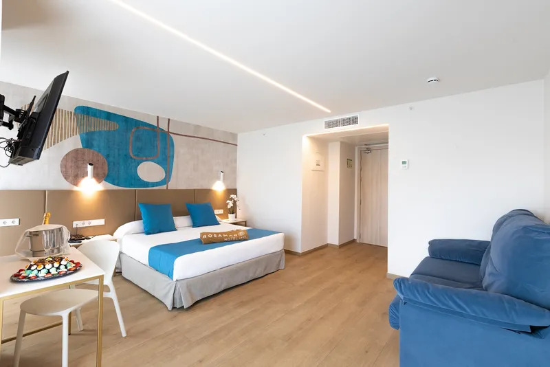 Rosamar: Family room, Double room with blue sofa bed and wall mural
