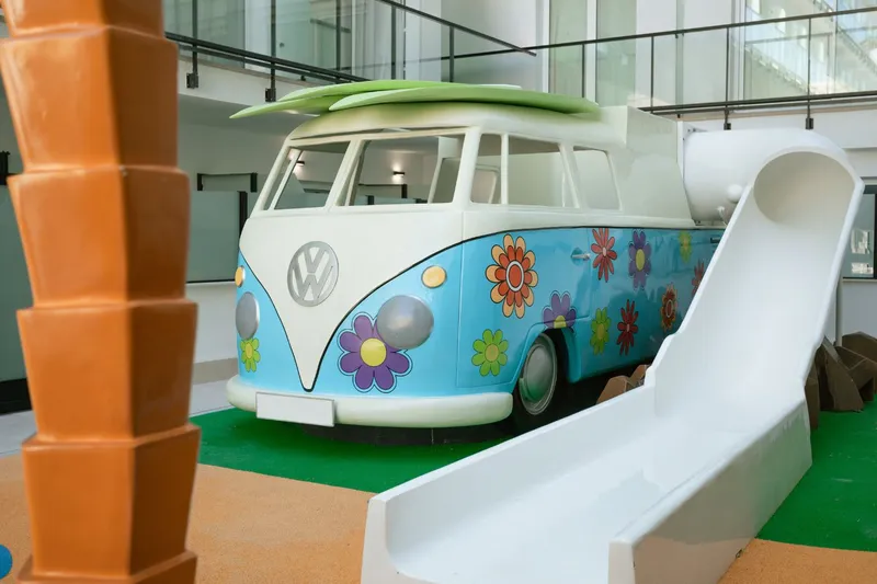 Villa España: Kids area, Camper-van play house with slide on artificial grass