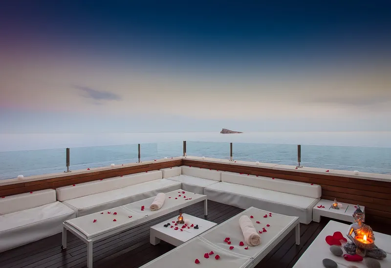 Villa Venecia: Chill-out terrace, White sofas and petals on a terrace at dusk