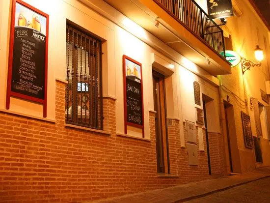 Irati: Street front, Brick front with menu boards lit at night