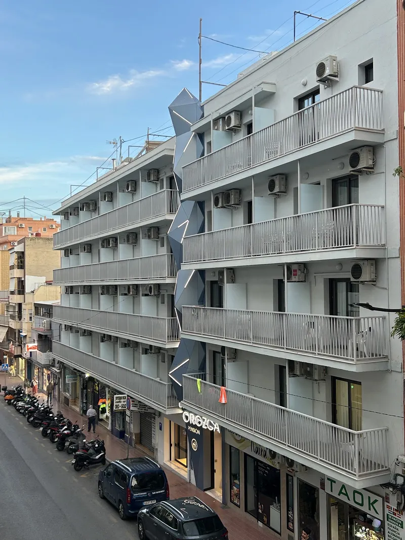 La Orozca: The building, White building with balconies on a narrow street